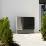 a air conditioner sitting on the side of a building